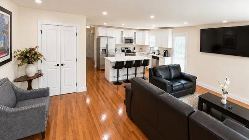 Living room and open kitchen in one of our 3-bedroom apartments, Hyde Park, Boston